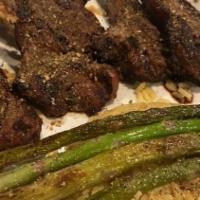 4 Grilled Lamb Chops With Seasoned Yellow Rice And Sautéed Asparagus · Juicy marinated lamb chops, charbroiled for the perfect smoky flavor served with seasoned ye...