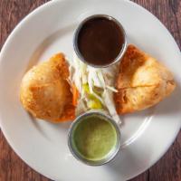 Vegetable Samosa · Hand rolled pastry stuffed with potato and green peas.