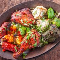 Tandoori Mix Grill · Two piece malai kabab, two piece hariyali chicken, two piece lamb seekh kabab, two piece tig...
