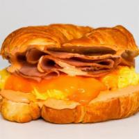 Croissant, Ham, Egg, & Cheddar Sandwich · 2 scrambled eggs, melted Cheddar cheese, sliced ham (turkey based) , and Sriracha aioli on a...