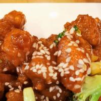 Sesame Chicken · Deep-fried chicken with sweet and sour sauce sauce garnished with sesame seeds.