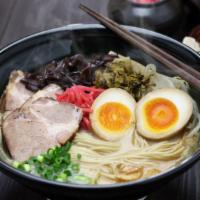 Ramen Tonkotsu · Fresh bowl of Japanese noodle soup made with pork bone broth and fresh vegetables and season...