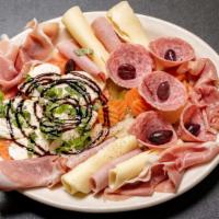 Antipasto Classico · Genoa salami, ham, provolone cheese, giardiniera, & kalamata olives over green leaf lettuce.