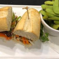 Pork Banh Mi · Vietnamese pork sandwich served with pickled carrots, daikons, jalapenos, cilantro, & bean s...