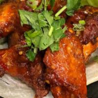 Thai Chicken Wings · Chicken wings tossed in our house made spicy Thai sauce.