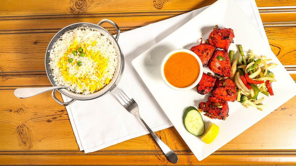 Chicken Tikka · Boneless pieces of chicken marinated overnight with exotic Indian herbs and spices.