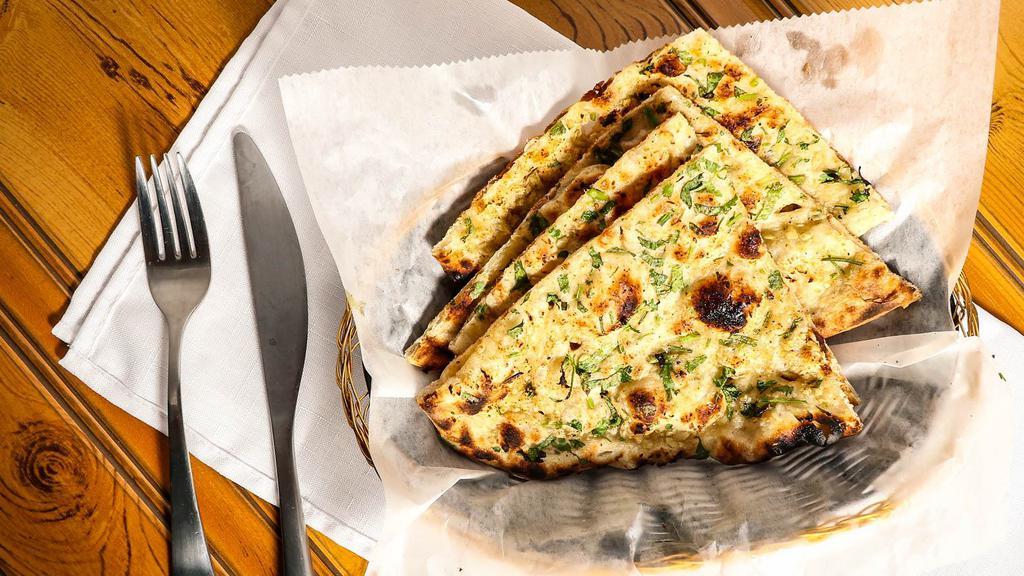Garlic Naan · Leavened white flour bread topped with garlic and herbs.