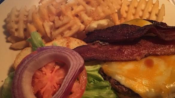 The Tavern Burger · Our signature burger topped with Colby Jack cheese, thick sliced bacon and homemade BBQ sauce with lettuce, tomato and onion.