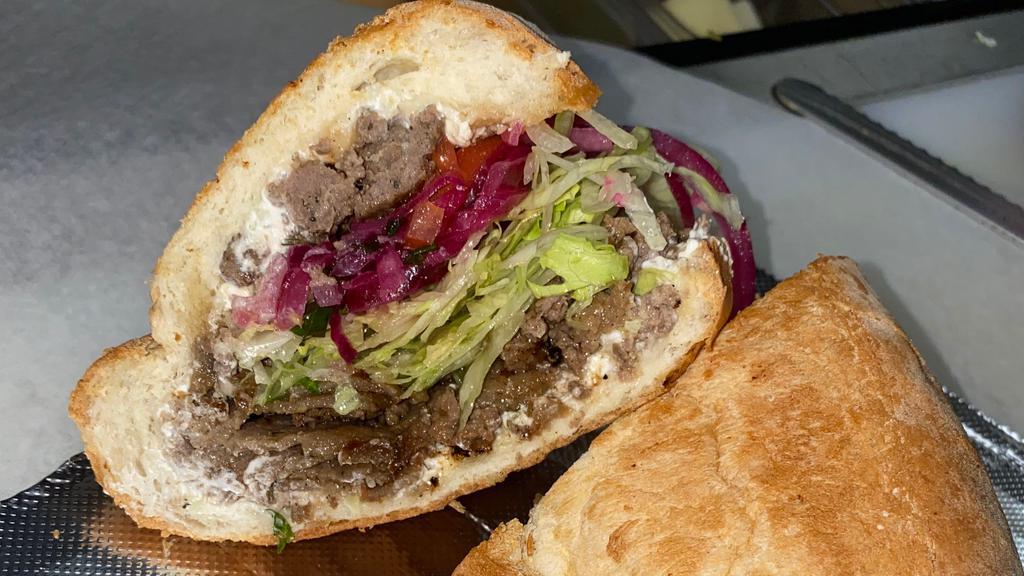#67 Istanbul · Seasoned ground beef and Gyro meat, tzatziki sauce, red onions, lettuce, and tomatoes