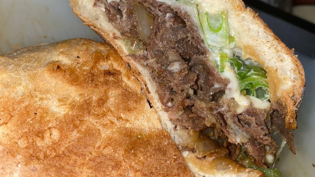 #17 Mongolian Beef · Grilled Steak, onions, peppers, topped with mozzarella cheese, green onions,carrots and a touch of mayo