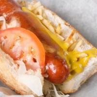 #64 Colombian Hot Dog · Beef Hot Dog served with thin sliced cabbage, tomatoes, Colombian pineapple sauce, potato st...