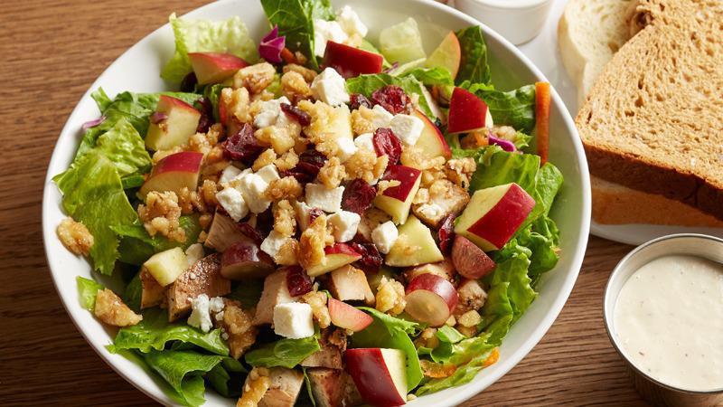 Waldorf Salad | Apple Cider Vinaigrette · Tender chicken breast, apples, grapes, dried cranberries, candied walnuts, and feta cheese on top of fresh salad greens.