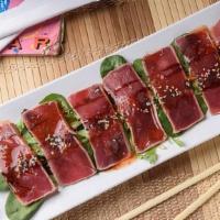 Tuna Tataki · Red tuna lightly seared, sliced, drizzled with sweet chili, ponzu and eel sauces and finishe...