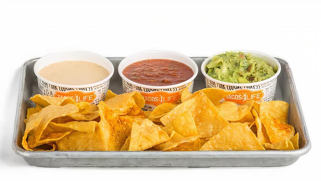 Ultimate Trio · A personal portion of our house-made salsa, classic queso, guacamole, and our magic seasoning seasoned tortilla chips.