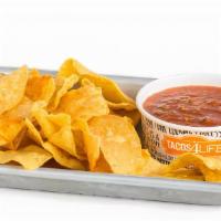 Personal Queso · A personal portion of our house-made classic queso and our magic seasoning seasoned tortilla...