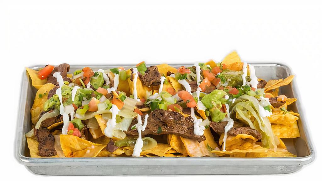 Ultimate Nachos · Refried black beans, house-made queso, sautéed onions and peppers, guacamole, pico de gallo, and sour cream.