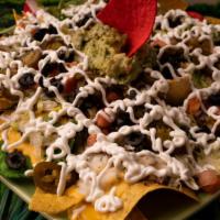 Nachos · Corn chips, choice of chicken fajita, ground beef, or pollo deshebrado, and queso or mixed c...
