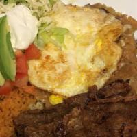 Chilaquiles  · 2 Fried Eggs & Carne Asada on a bed of tortilla Chips with green sauce on top. Comes with ri...