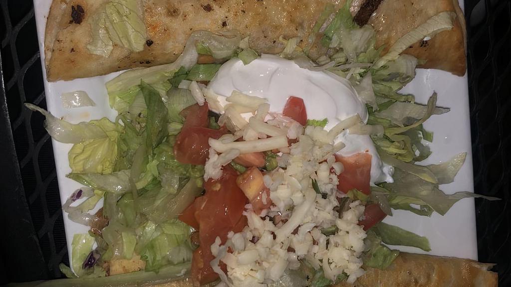 Quesadillas Rellenas · Comes with 2 flour tortillas grilled and stuffed with your choice of meat, cheese and beans. Topped with lettuce, guacamole, sour cream, and tomatoes