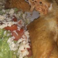 Chicken Flautas · Two fried flour tortillas filled with chicken. Served with rice, beans, lettuce, sour cream,...