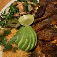 Mojarra · Whole tilapia deep-fried, served with rice, salad, avocado slices, cactus, grilled bunch oni...