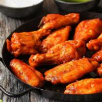 Buffalo Chicken Wings · Golden - crispy oven baked chicken wings dipped in spicy buffalo sauce.