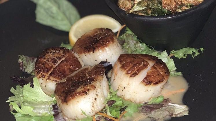 Seared Sea Scallops · White wine lemon-herb butter sauce, on a bed of asparagus, served with mashed potato.