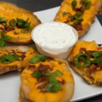 Potato Skins · Stuffed with cheese, bacon, sour cream and scallions.