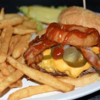 The Real Cowboy Burger · House BBQ sauce, sauteed onions, jalapeno, bacon and cheese topped with an onion rings. ½ po...