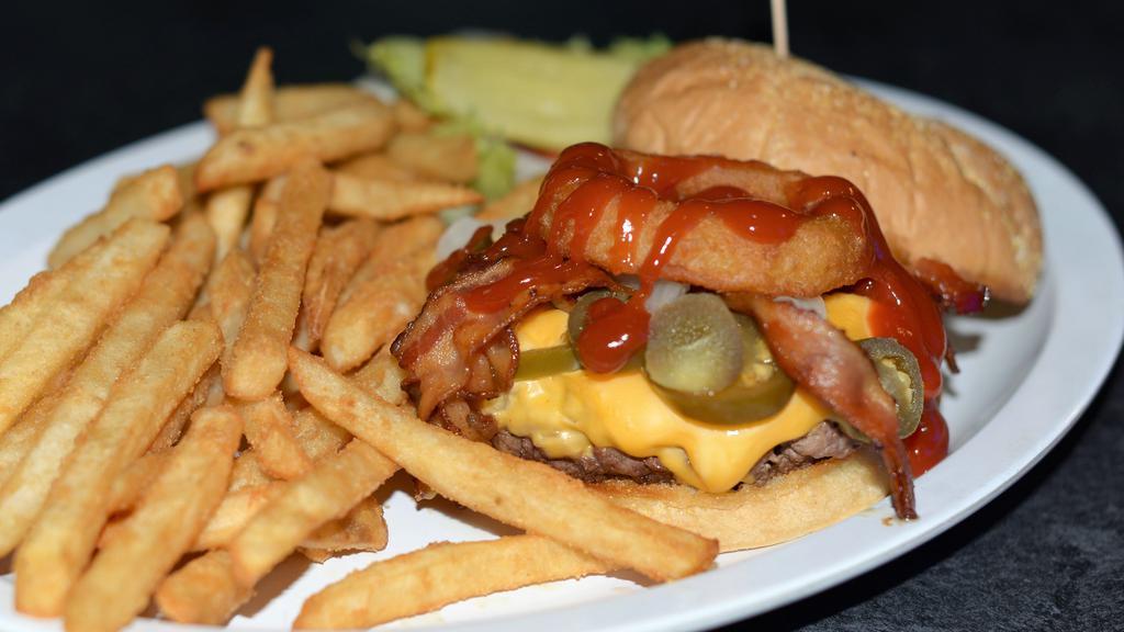 The Real Cowboy Burger · House BBQ sauce, sauteed onions, jalapeno, bacon and cheese topped with an onion rings. ½ pound served with french fries or chips and pickle.