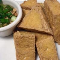 Fried Tofu · Deep fried tofu. Served with sweet and sour sauce and topped with crushed peanuts.