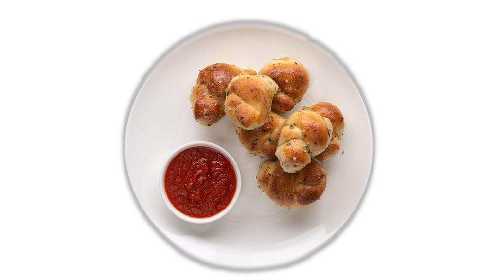 Garlic Knots (8) · Freshly Baked with savory blend of Fresh Garlic, Virgin Olive Oil, Oregano & Parsley finished with Parmesan. Served with Marinara on the side.
