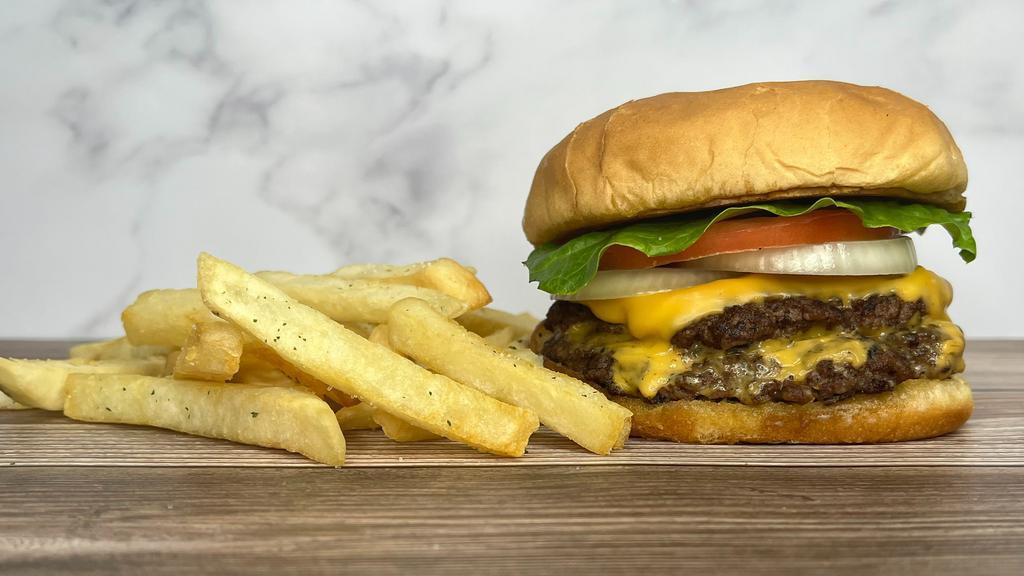 Smash Burger Combo · Two slices of melted American cheese between two Angus beef patties cooked- to- order,
sandwiched between a buttered bun Fries and Drink included