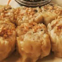 Dumplings · Steamed wonton skin filled minced chicken, shrimp, mushrooms and water chestnuts served with...