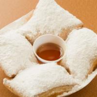 Beignets (4 Pieces) · Our light, fluffy dough fried to perfection and covered with powdered sugar.
