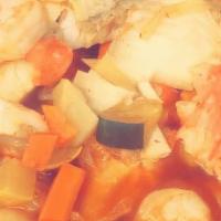 Caldo Costa Azul · Seafood soup with crab legs, fish, scallops, shrimp, and vegetables.