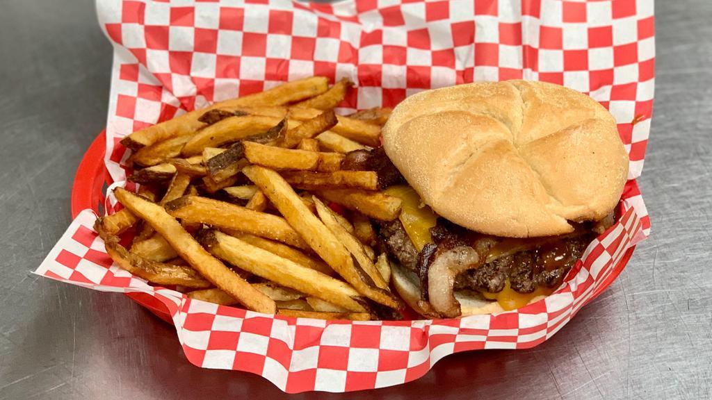 Kit Carson Burger · 1/2 lb. burger topped with cheddar cheese and bacon on a toasted hamburger bun. Served with a side of hand-cut fries.