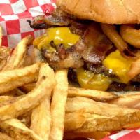 Johnny Ringo · 1/2 lb. burger topped with cheddar cheese, crispy bacon, homemade BBQ sauce and onion rings ...