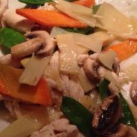 Moo Goo Gai Pan · Sliced white chicken meat stir-fried with mushrooms, carrots, and snow peas in a white sauce.