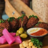 Falafel · Favorite. Organic chickpeas coarsely ground and mixed with fresh parsley, cilantro, onions, ...