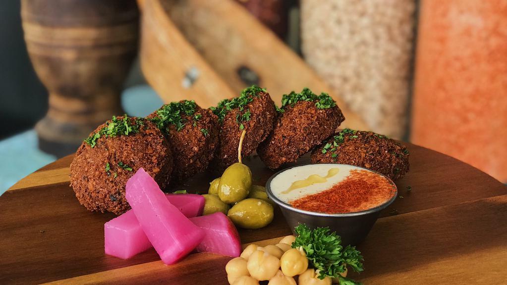 Falafel · Favorite. Organic chickpeas coarsely ground and mixed with fresh parsley, cilantro, onions, garlic, and spices. This delicious mixture is formed into small patties and fried to a perfect crispy-golden brown. Served with a side of tahini sauce.