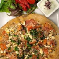 Jebneh · Mediterranean small pizza. Crumbled feta, diced tomatoes, fresh oregano with lemon olive oil...