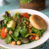 House Salad · Romaine, organic greens, roma tomatoes, English cucumbers, shredded carrots, and chickpeas t...