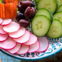 Raw Veggies · Fresh seedless cucumbers, green and red bell peppers, radishes, and kalamata olives.