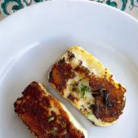 Grilled Halloumi Cheese (2) · 2 Slices of imported Greek cheese made from sheeps and goat milk.