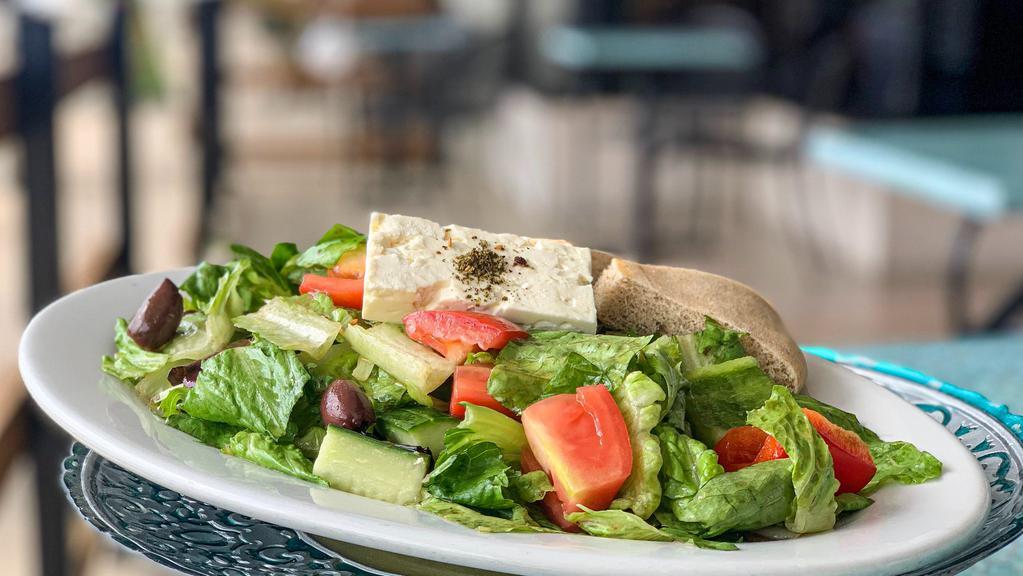 Greek Salad (Lunch) · Crisp romaine and organic mixed greens, Roma tomatoes, English cucumbers, Kalamata olives, Green and Red bell peppers, and authentic Greek feta. Comes with our authentic Greek dressing and homemade pita bread.