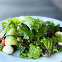 Baladi Salad (Lunch) · Crisp romaine and organic mixed greens, fresh mozzarella, artichoke hearts, Roma tomatoes, E...