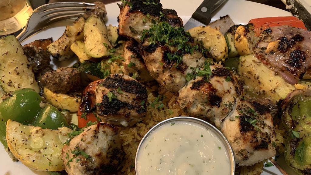 Chicken Kebab Platter (Lunch) · Kebab skewer marinated in various mediterranean spices, then char-grilled to order and served on a bed of basmati rice with grilled vegetables and a side of homemade tzatziki sauce.