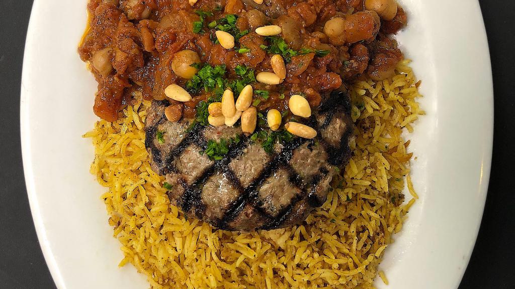 Kufta (Lunch) · Middle eastern style minced beef and lamb patty with fresh herbs and spices, grilled and served on a bed of basmati rice and topped with a sauce made of sauteed tomatoes, chickpeas, onions, garlic, and garnished with toasted pine nuts.