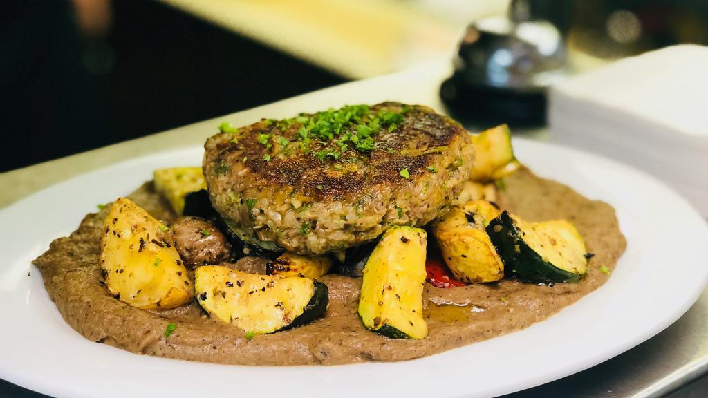 Heavenly Veggie Patty · Red split lentils, whole brown lentils, brown rice, organic quinoa, roasted red peppers, walnuts, and artichoke hearts  make up this patty served over grilled vegetables and a roasted eggplant puree.